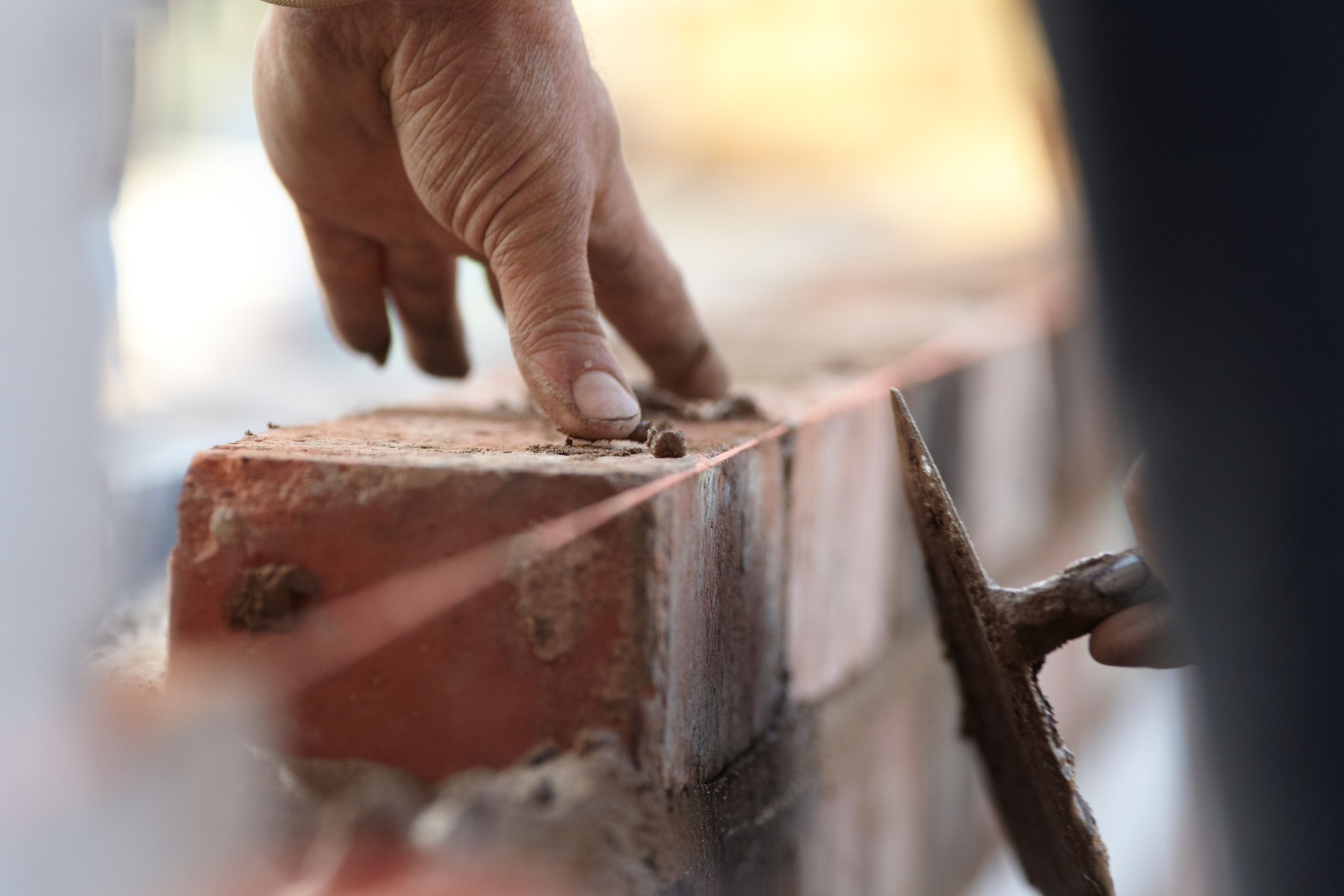 Bricklayer Building A New Extension With Reclaimed Bricks